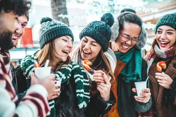 Foto op Aluminium Happy friends having fun drinking mulled wine and hot chocolate at Christmas Market - Cheerful young people enjoying winter holidays on weekend vacation - Tourism lifestyle and friendship concept © Davide Angelini