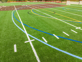 Obraz premium New synthetic turf field with football and baseball with lines and graphics. 
