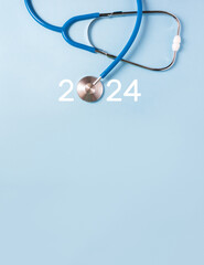 Medicine stethoscope and numbers 2024 on blue background. Happy New Year medical calendar cover....