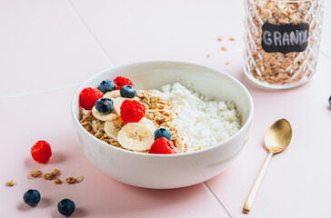 Healthy protein Cottage cheese breakfast bowl with granola, blueberry and raspberry