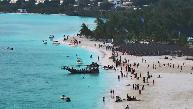 Zanzibar beach where tourists and locals mix together of colors and joy, concept of summer vacation, aerial view of Kendwa beach, Tanzania