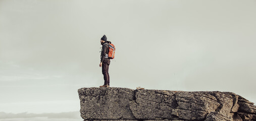 man standing on top of a rock in nature