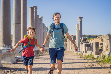 dad and son tourists at the ruins of ancient city of Perge near Antalya Turkey. Traveling with kids concept