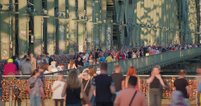  Crowd of tourist people walk on Hohenzollern bridge in Cologne, Germany. Timelapse