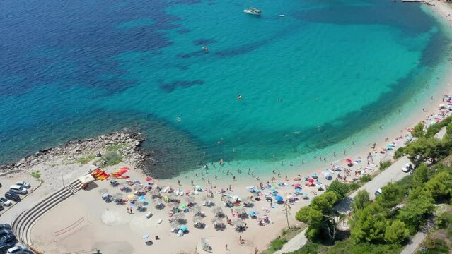 Beach in Croatia. Bay with perfect clean water. People sunbathing swimming