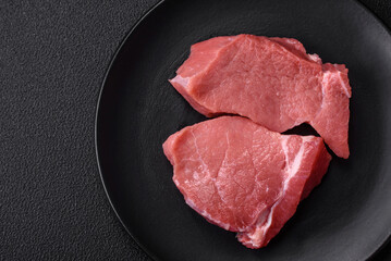 Raw fillet steak mignon beef with salt, spices and herbs