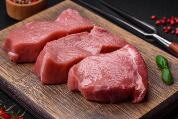 Raw fillet steak mignon beef with salt, spices and herbs
