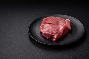 Raw fillet steak mignon beef with salt, spices and herbs