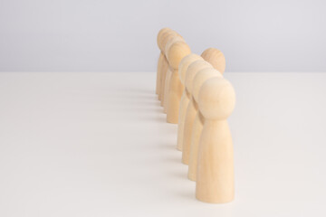 concept of candidates for work. wooden figures lined up in a row. close up