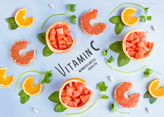 Collection of vitamin C sources. Fruits  enriched with ascorbic acid: orange, grapefruit, spinach, parsley
Dietetic food, organic nutrition composition. Flat lay. Top view.
