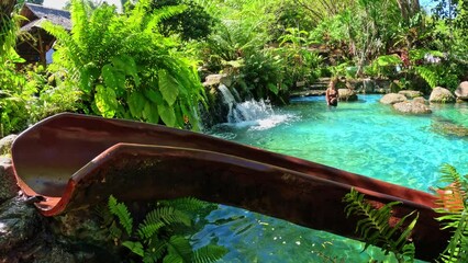 A girl rolls down a water slide