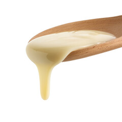 condensed milk in wooden spoon