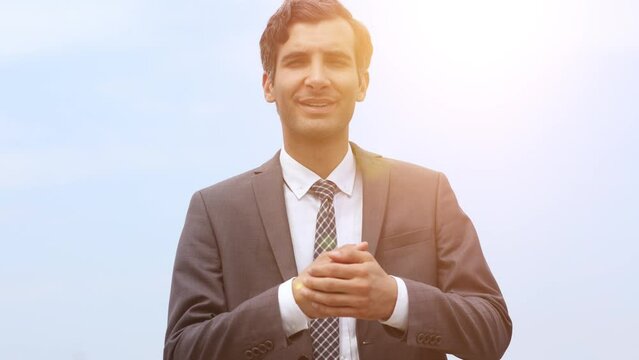 Modern businessman smiles and stretches his hand to the camera wishing to greet