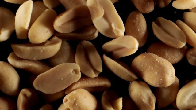 Peanuts seeds close-up. Salted roasted peanuts. Salty snack. Salted peanuts snack food.