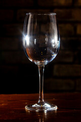 Empty glass with reflections on dark background