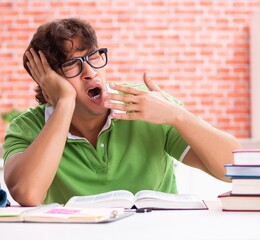 Young student preparing for exams at home