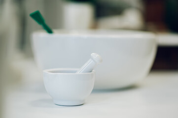 Close up of a mortar and pestle on a table in a vintage apothecary.