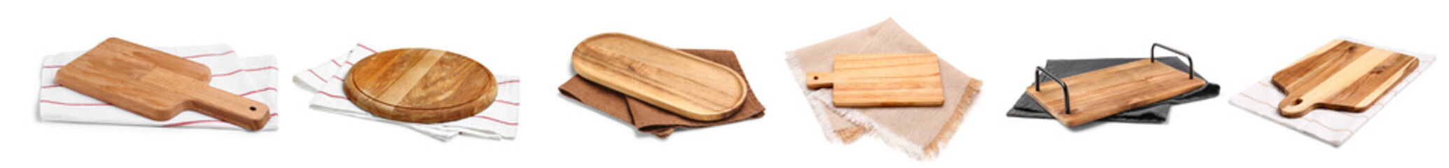 Set of wooden boards with napkins on white background