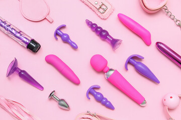 Different sex toys on pink background