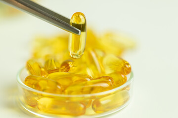 Golden capsules, omega 3, supplements, modern laboratory, chemical tests