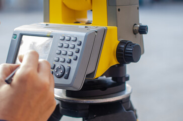 Civil engineer, surveyor is working with total station on a building site. Work tools