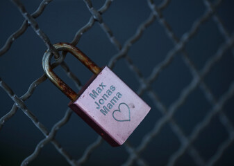 Old and new locks with names and dates written on them couples connection in love lock on a bridge as a sign of love in Dorsten Germany close up high quality instant printings