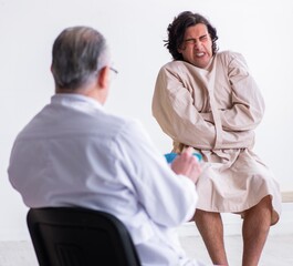 Aged male doctor psychiatrist examining young patient