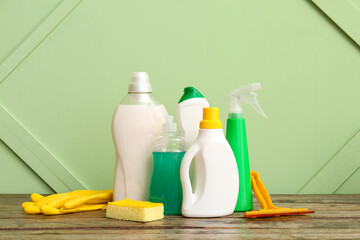Different cleaning supplies on wooden table