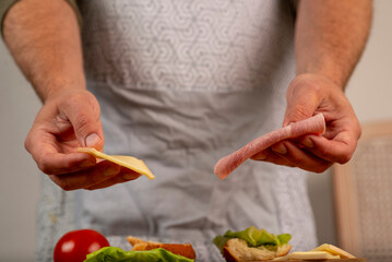 male hands preparing a burger at home