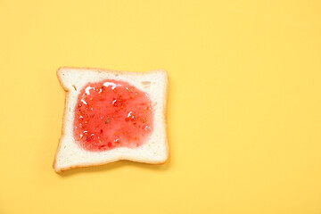 Tasty toast with jam on color background