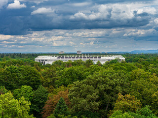 Big sport stadium aerial view in the green forest - 653464364