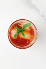 Glass of ice tea with mint on white background