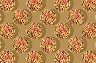 Pattern of pasta fusilli noodle in wooden bowl on yellow pastel background