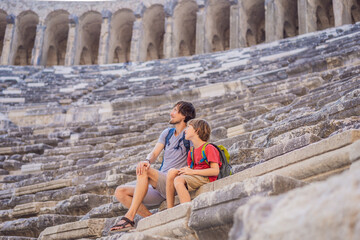 Father and son tourists explores Aspendos Ancient City. Traveling with kids concept. Aspendos...