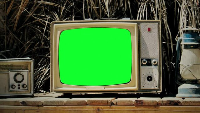 Vintage TV Green Screen Exterior Sunny Day Zoom In Old Television. Green screen vintage television on the exterior of a house on a sunny day. Zoom in