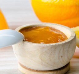 Orange jam served in spoon on the table