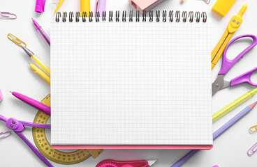Composition with blank notebook and different school stationery on white background, closeup