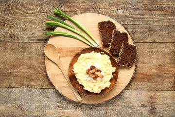 Plate of tasty banosh and bread on wooden background