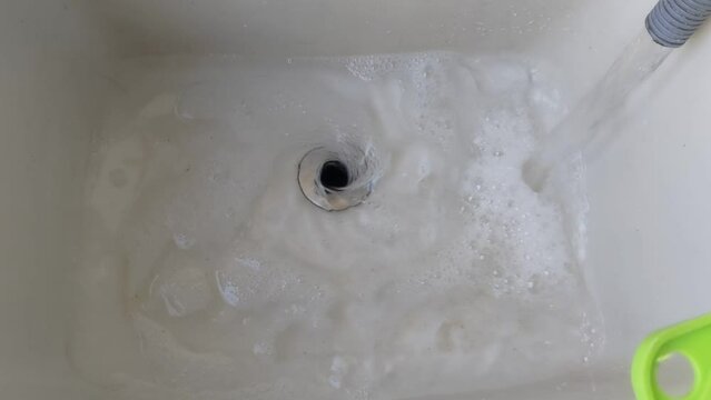 Water being discharged from the washing machine from upview