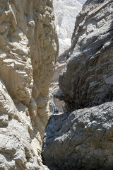 A camper seen among rocks in a large canyon