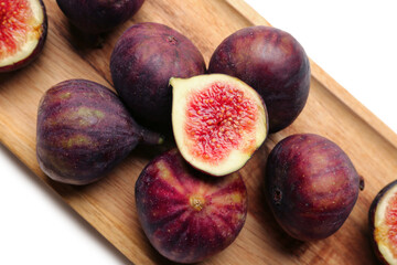 Wooden board with fresh ripe figs on white background