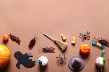 Halloween composition with candy bugs, eyeballs and ghost on brown background