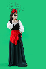 Beautiful woman dressed for Halloween on green background