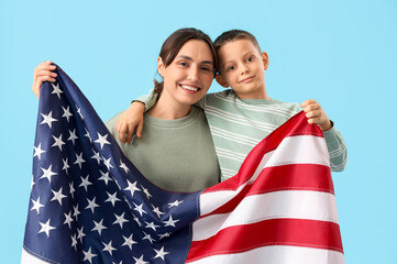Little boy and his mother with USA flag on blue background. Veterans Day celebration