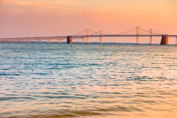 Fototapeta na wymiar Chesapeake Bay Bridge and water at beautiful orange and blue sunset