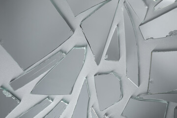 Shards of broken mirror on white background, top view