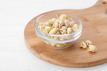 Sprouted kidney beans on white wooden table, closeup