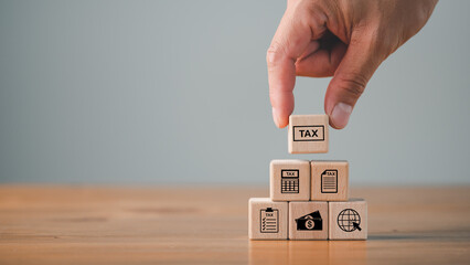 tax calculation concept, tax icon in the wooden cube for income tax return and submit tax for payment tax documents online to the government, Financial research. - obrazy, fototapety, plakaty