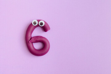 Number Six Made from Plasticine with Funny Eyes. Hilarious digit handmade from Play- dough material 
