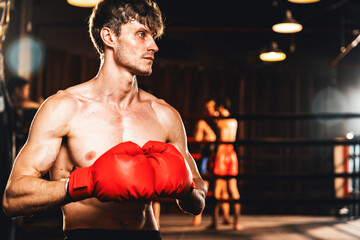 Boxing fighter posing, caucasian boxer put his hand or fist wearing glove together in front of...